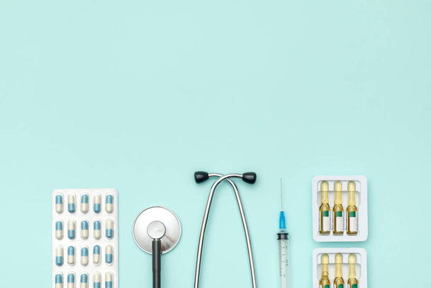 Top view of doctor's table with stethoscope and other equipment. Colored background. Top view. Flat lay - Foto, Imagen