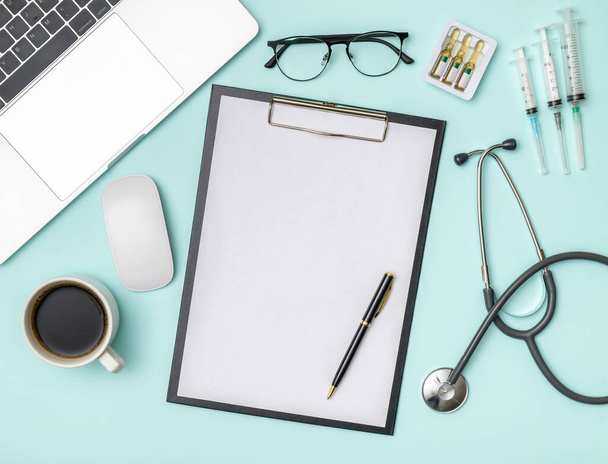 Medical healthcare background. Flat lay objects with copy space. Stethoscope, laptop computer on colored table. Medicine concept - Φωτογραφία, εικόνα