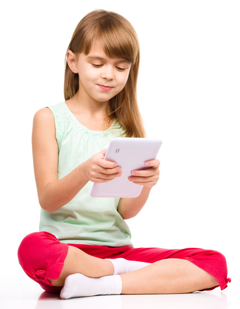 Young girl is using tablet - Foto, immagini