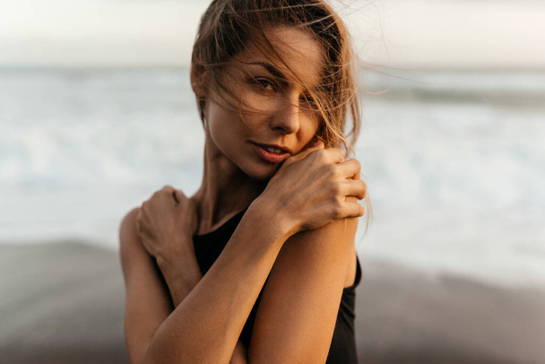 woman on beach is enjoying serene ocean nature during travel holidays vacation outdoors - Valokuva, kuva