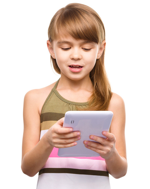 Young girl is using tablet - Φωτογραφία, εικόνα