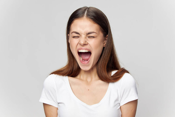 Emotional woman with closed eyes opened her mouth wide  - Photo, Image