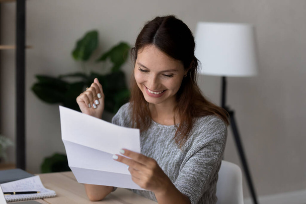 Happy young woman excited by news in paper letter - Foto, Imagem
