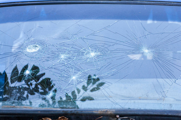 broken glass. Car glass cracked from an accident. Armored glass after impact. glass reinforced with a film after being hit by a bullet. - Photo, Image