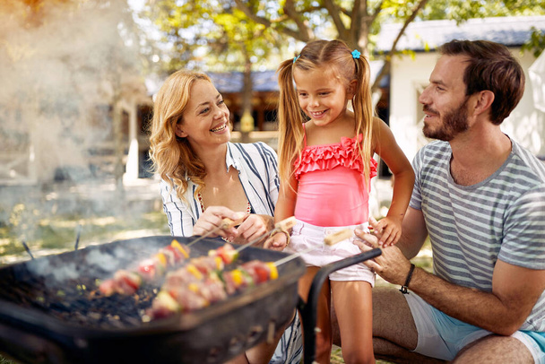 Family with his smiling children prepare fire for family  barbeque. - Valokuva, kuva