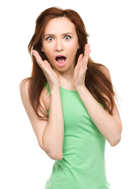 Woman is holding her face in astonishment - Photo, image