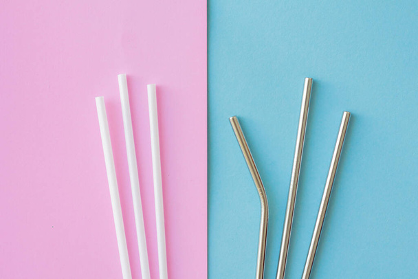 Flat lay of reusable stainless steel straw with plastic straw on pink and blue background. sustainable and zero wast concept. - Fotoğraf, Görsel