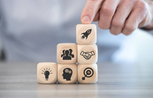Concept of business start-up with icons on wooden cubes - Photo, Image