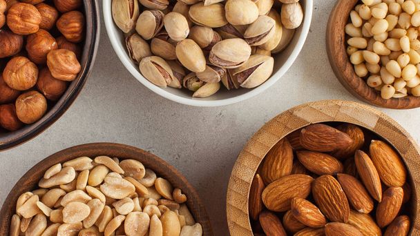 Banner assorted nuts. The dried nuts, hazelnuts, almonds and others. Healthy food, healthy snacks. High quality photo - Fotó, kép