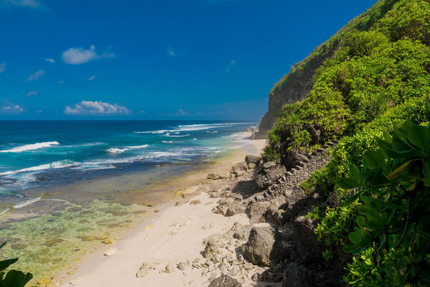 Tropical wild beach in Bali. Sandy beach and blue ocean - Photo, Image