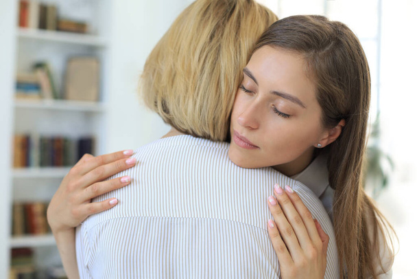 Concerned middle aged mother hugging her adult daughter, listen her anxieties - Photo, image