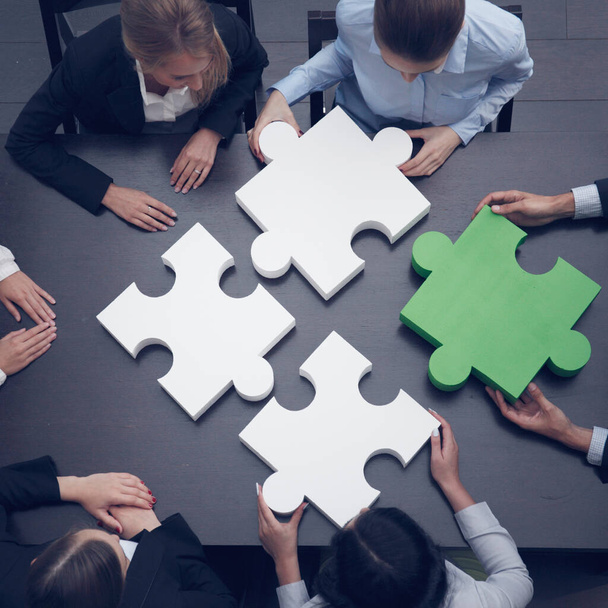Group of business people assembling jigsaw puzzle, team support and help concept - Photo, image