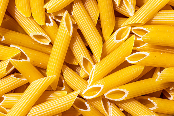 Πολύχρωμο ιταλικό pasta penne αφηρημένο σκηνικό. Παραδοσιακό φαγητό. Υφή. - Φωτογραφία, εικόνα