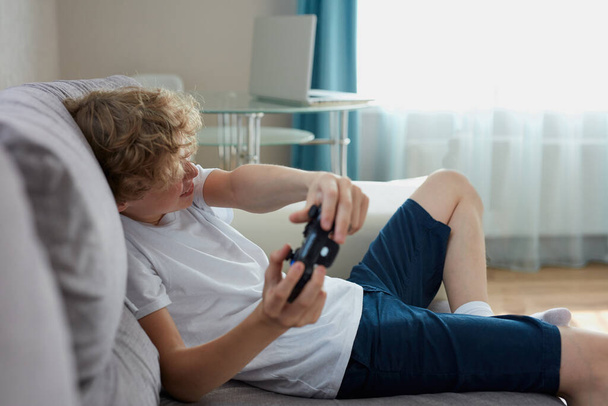playful teenager keen on video games - Foto, immagini