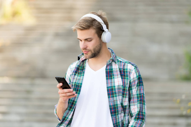 Busy man wireless headphones use smartphone, modern communication concept - Foto, immagini