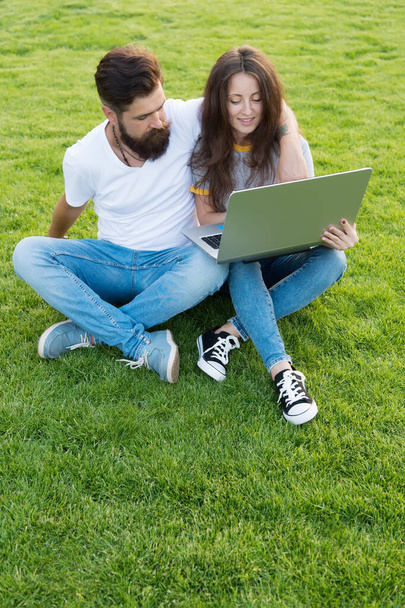 Girl and hipster man with laptop outdoors, web development concept - Photo, Image