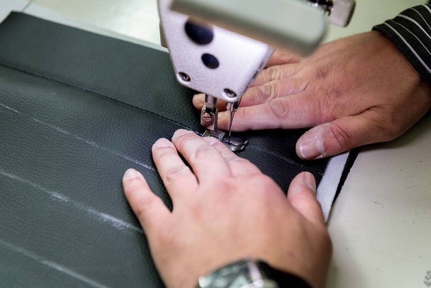Designer tailor sew seat covers. Man use sewing machine for his work. - Фото, зображення