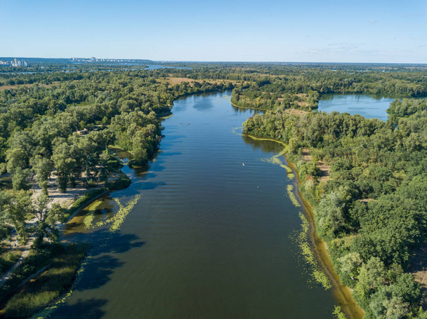 Green bank of the Dnieper river on a summer sunny day. Aerial drone view. - Photo, Image