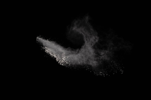 White powder explosion on black background. Colored cloud. Colorful dust explode. Paint Holi. - Photo, Image