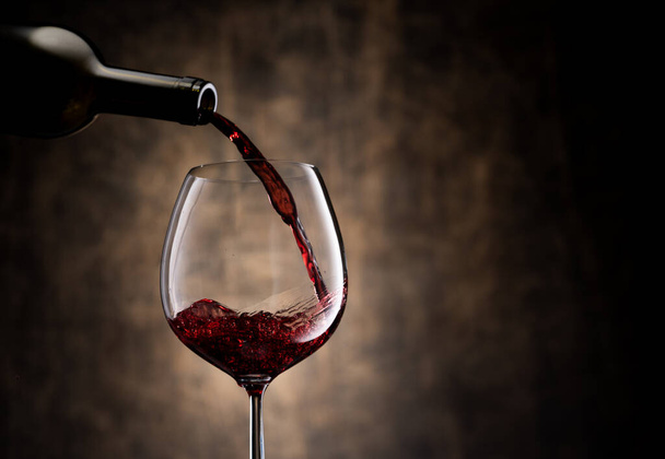 Red wine pouring into glass - Foto, Imagen