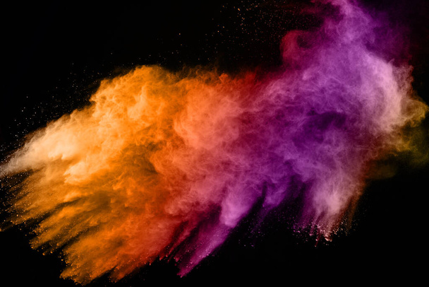 explosión de polvo de color abstracto sobre un fondo salpicado de polvo background.abstract negro, congelar el movimiento del polvo de color que explota / tirar polvo de color, textura de brillo multicolor. - Foto, Imagen