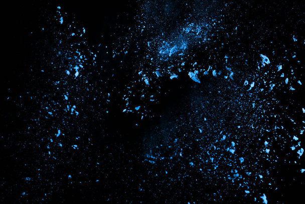 Blue powder explosion on black background. Colored cloud. Colorful dust explode. Paint Holi. - Fotó, kép