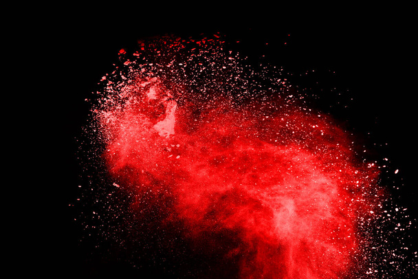 abstract red powder explosion on black background.abstract red powder splatted on black background. Freeze motion of red powder exploding. - Fotoğraf, Görsel