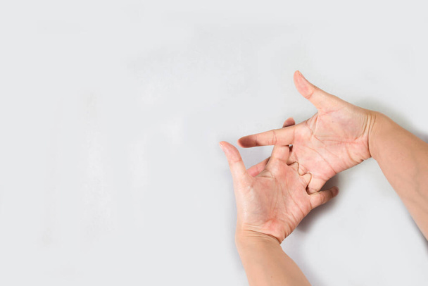 Young beautiful woman has pains in a hand. The hand hurts a woman isolated on white background. Close up Woman holding her hand, pain concept, Office Syndrome. - Fotografie, Obrázek