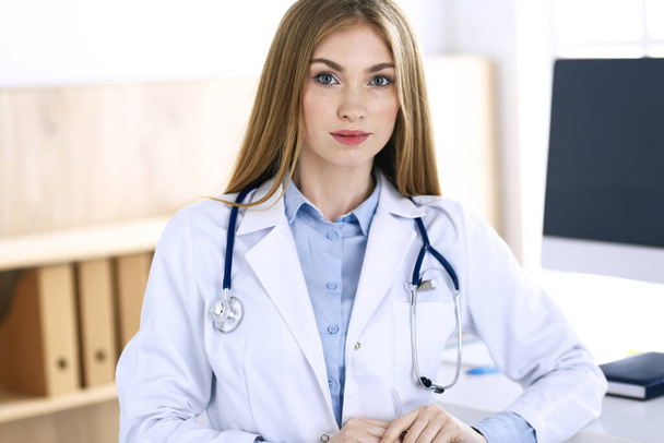 Woman doctor standing in hospital office. Physician at work, life portrait. Medicine and health care concept - Foto, Imagem