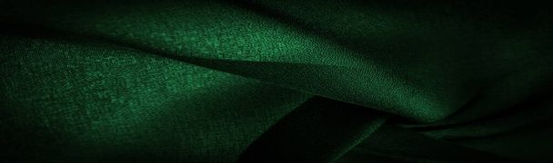 Background texture Dark green chiffon silk is a soft transparent fabric with a slight roughness (matte, creped) due to the use of twisted yarn. - Photo, Image