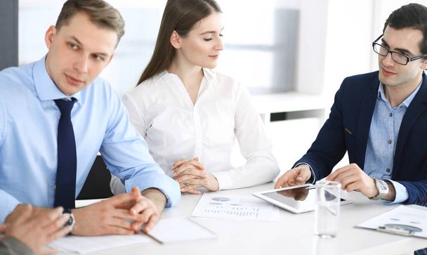 Group of business people discussing questions at meeting in modern office. Headshot at negotiation or workplace. Teamwork, partnership and business concept. - Фото, зображення