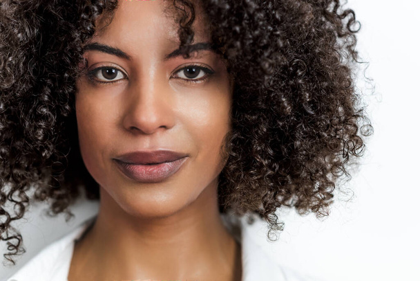 portrait of an attractive afro woman looking to camera with copy space on the right - Photo, Image