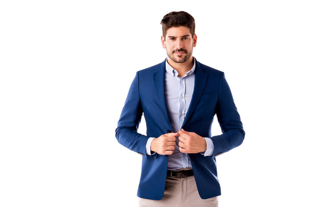 Studio shot of handsome businessman wearing shirt and blazer while standing at isolated white background with copy space. - Foto, imagen