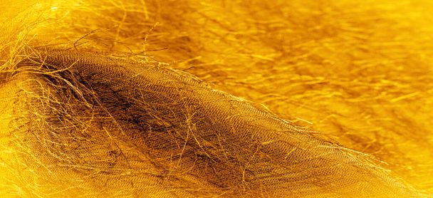 Background texture, decorative ornament, yellow gold silk fabric, woven threads on the fabric, fluffy effect, sensation, appearance or texture of a surface or substance - Foto, Imagen