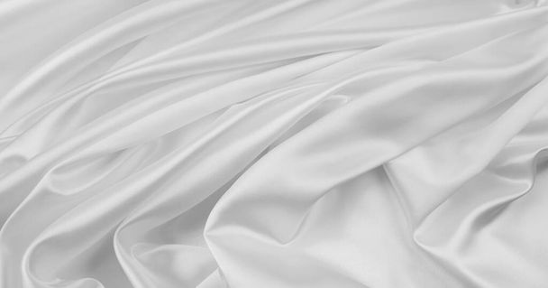 Closeup of rippled white silk fabric lines - 写真・画像
