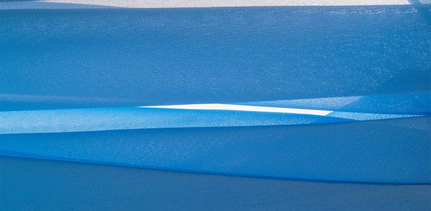テクスチャの背景パターン。青い絹の生地少しマットな光沢のあるデュオニの軽い人工絹の生地です。あなたのデザイン、アクセント、壁紙、ポスターやカードに最適です。. - 写真・画像