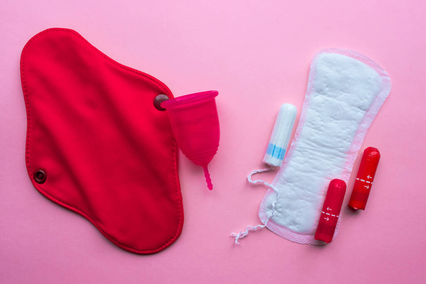 Menstrual cup and Reusable Menstrual Pad versus disposable pad and tampon. Flat lay on pink background. Zero waste concept. Caring for the environment. Women Health. - Foto, Bild