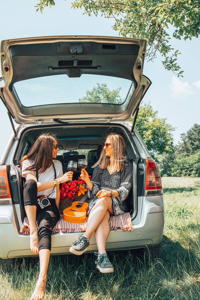 Two female friends travel around the world in a car. Vacation concept. - Foto, immagini