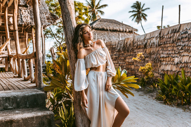 beautiful young stylish woman model posing at tropical resort background - Photo, Image