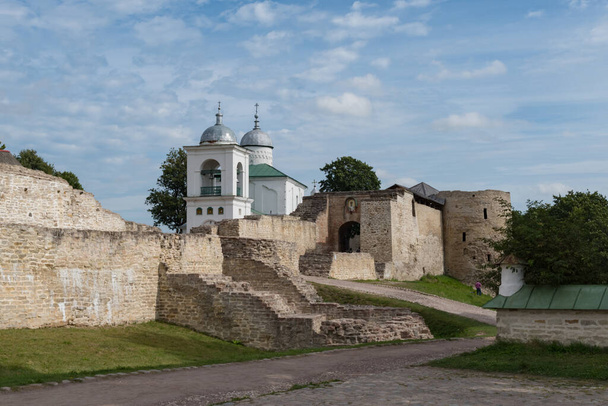 Vue sur l'ancienne forteresse d'Izborsk, la manche de défense de Nikolsky, les portes et la cathédrale Saint-Nicolas du XIVe siècle derrière les murs fortifiés. Région de Pskov, Russie. - Photo, image