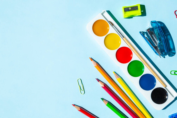 Bright set of office supplies. Pencils, notebook, pens, crayons, glue. With copy space - Foto, immagini