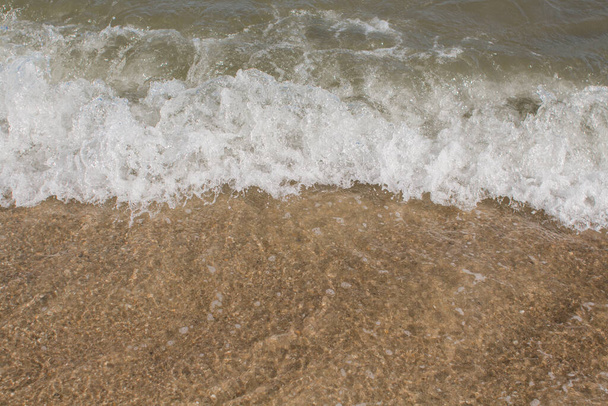sea waves on a sandy shore in afternoon - Valokuva, kuva