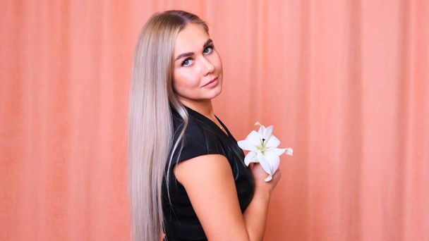 Beautiful female with healthy long straight blond hair. Dyed wavy white blond hair background, dyeing, extensions, treatment, treatment concept. Hair care. Slow motion 4K UHD video - Foto, afbeelding
