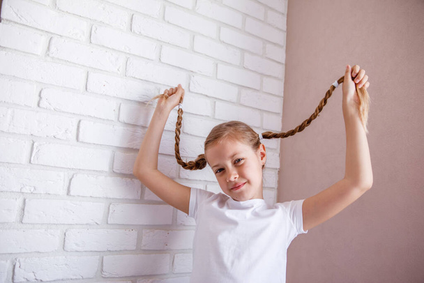 braided hair. Cute Little girl with two pigtails - Foto, Imagem