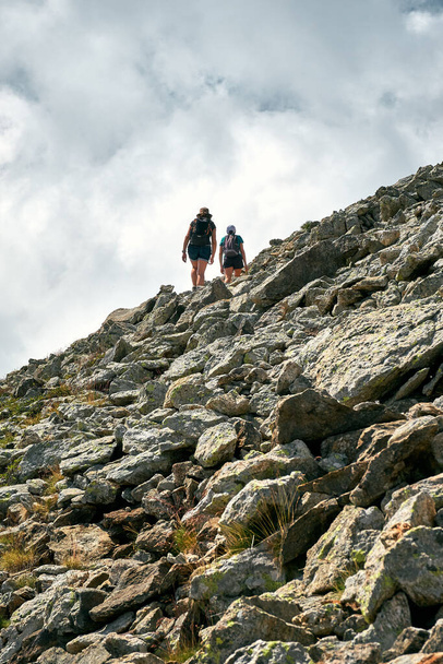 A back view photo of hikers climbing a slope of a mountain in the French Riviera - 写真・画像