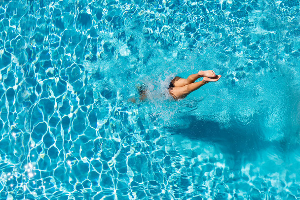 woman diving  at luxury five stars  spa resort in the swimming pool in Greece - Fotó, kép