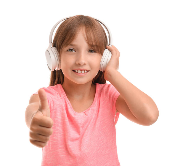 Little girl listening to music on white background - Photo, image