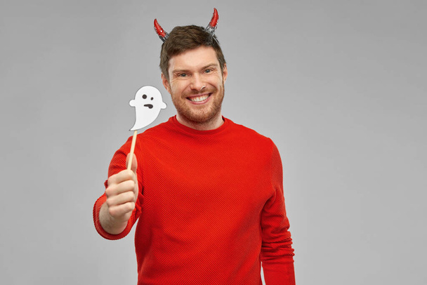 happy man in halloween costume of devil over grey - Fotó, kép