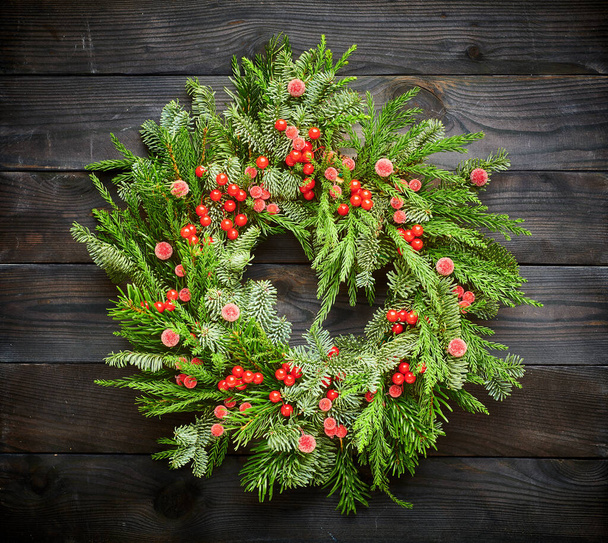 Christmas wreath on dark rustic wooden background - Photo, Image