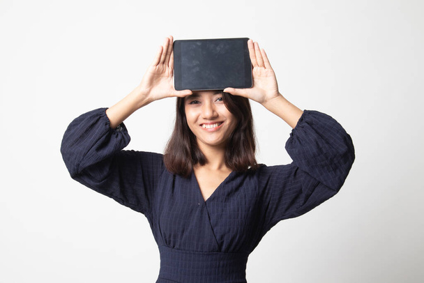 Young Asian woman with a computer tablet over her face on white background - Zdjęcie, obraz